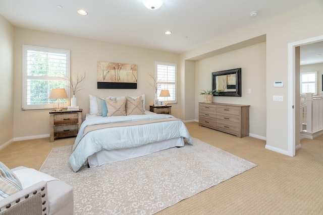 a large beige bedroom with a bed and carpet